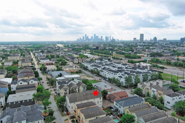 an aerial view of a house with a backyard space