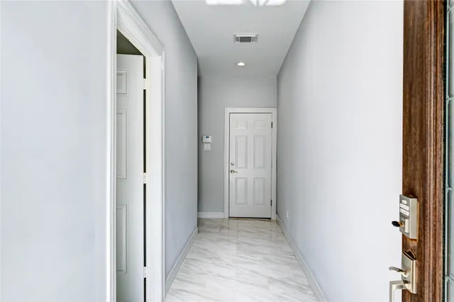 a view of a hallway with a white walls