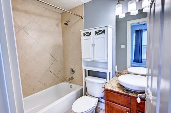 an empty room and chandelier fan