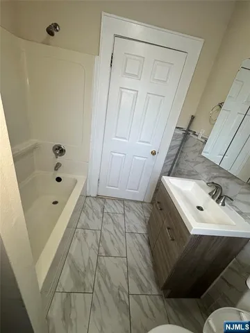 a bathroom with a bathtub and shower