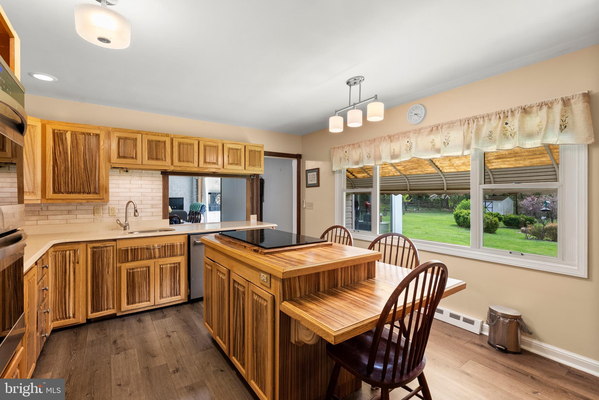 6605 Mt Vista Road Kingsville, MD 21087 - Photo 18 of 54 a kitchen with stainless steel appliances granite countertop a stove a sink dishwasher and a dining table with garden view