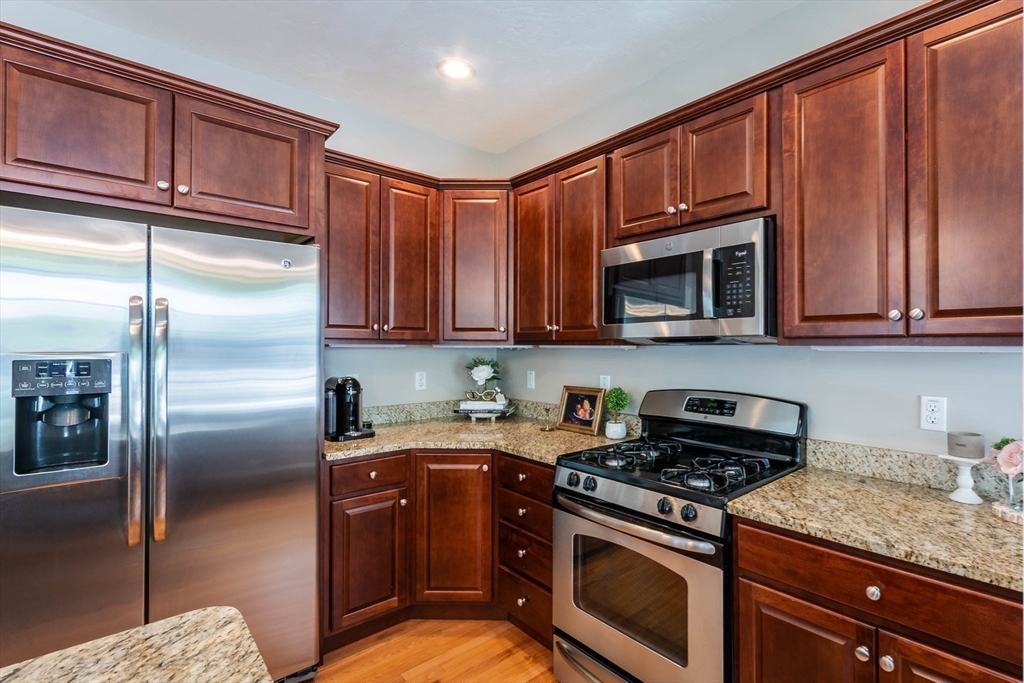 493 Taylor Road Stow, MA 01775 - Photo 11 of 40 a kitchen with stainless steel appliances granite countertop a refrigerator stove top oven