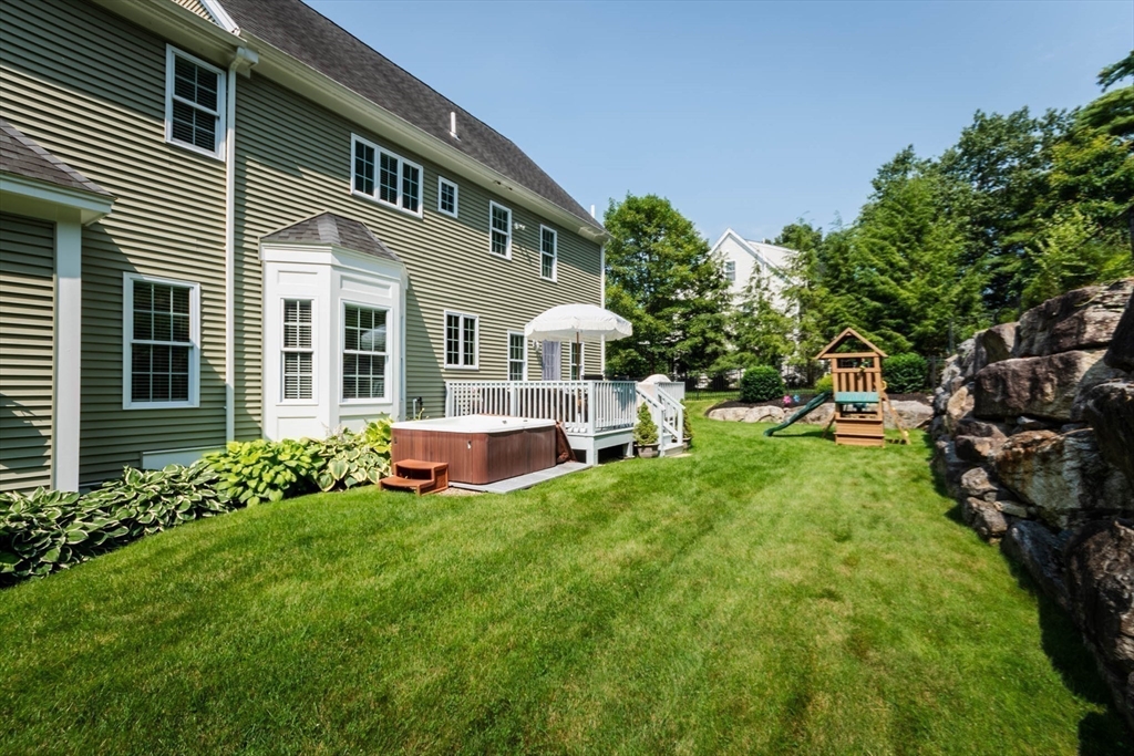 493 Taylor Road Stow, MA 01775 - Photo 17 of 40 a front view of a house with yard and green space