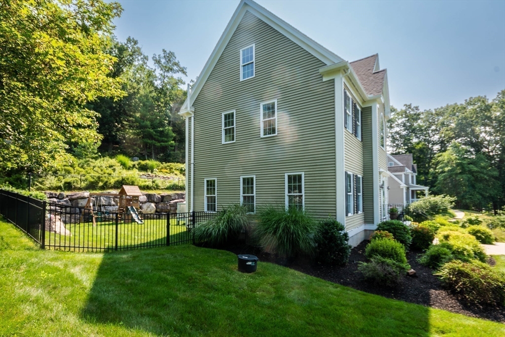 493 Taylor Road Stow, MA 01775 - Photo 18 of 40 a front view of a house with a yard