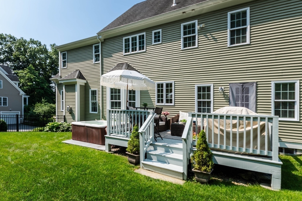 493 Taylor Road Stow, MA 01775 - Photo 19 of 40 a front view of a house with a yard chairs and a yard