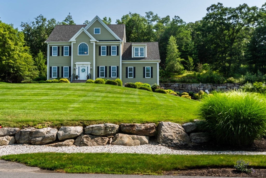 493 Taylor Road Stow, MA 01775 - Photo 2 of 40 a front view of a house with a yard