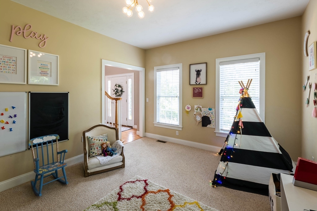 493 Taylor Road Stow, MA 01775 - Photo 24 of 40 a living room with furniture a flat screen tv and a window