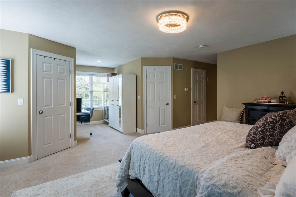 493 Taylor Road Stow, MA 01775 - Photo 29 of 40 a bedroom with a bed and a cabinets