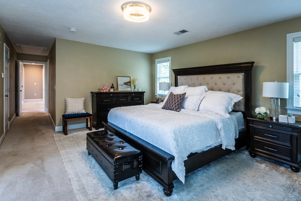 493 Taylor Road Stow, MA 01775 - Photo 30 of 40 a bedroom with a bed and a lamp on table