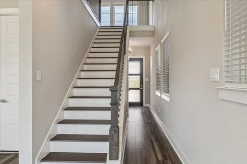 a view of entryway with wooden floor and windows