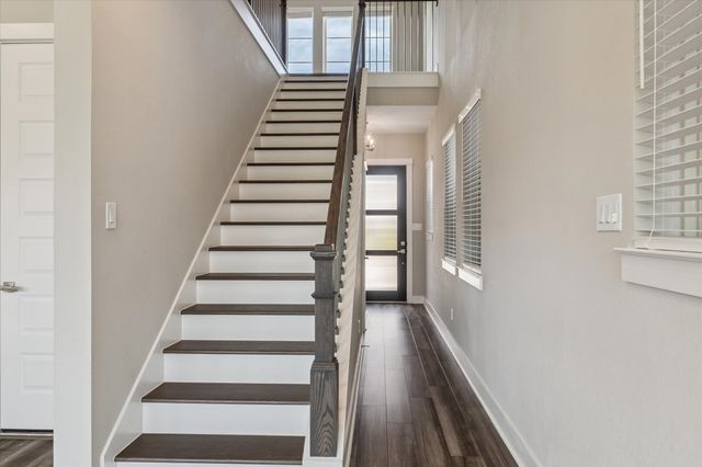 a view of entryway with wooden floor and windows