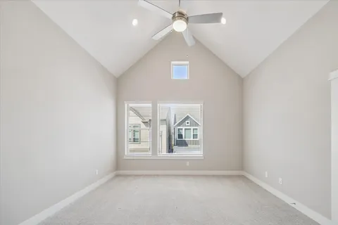 an empty room with windows and ceiling fan