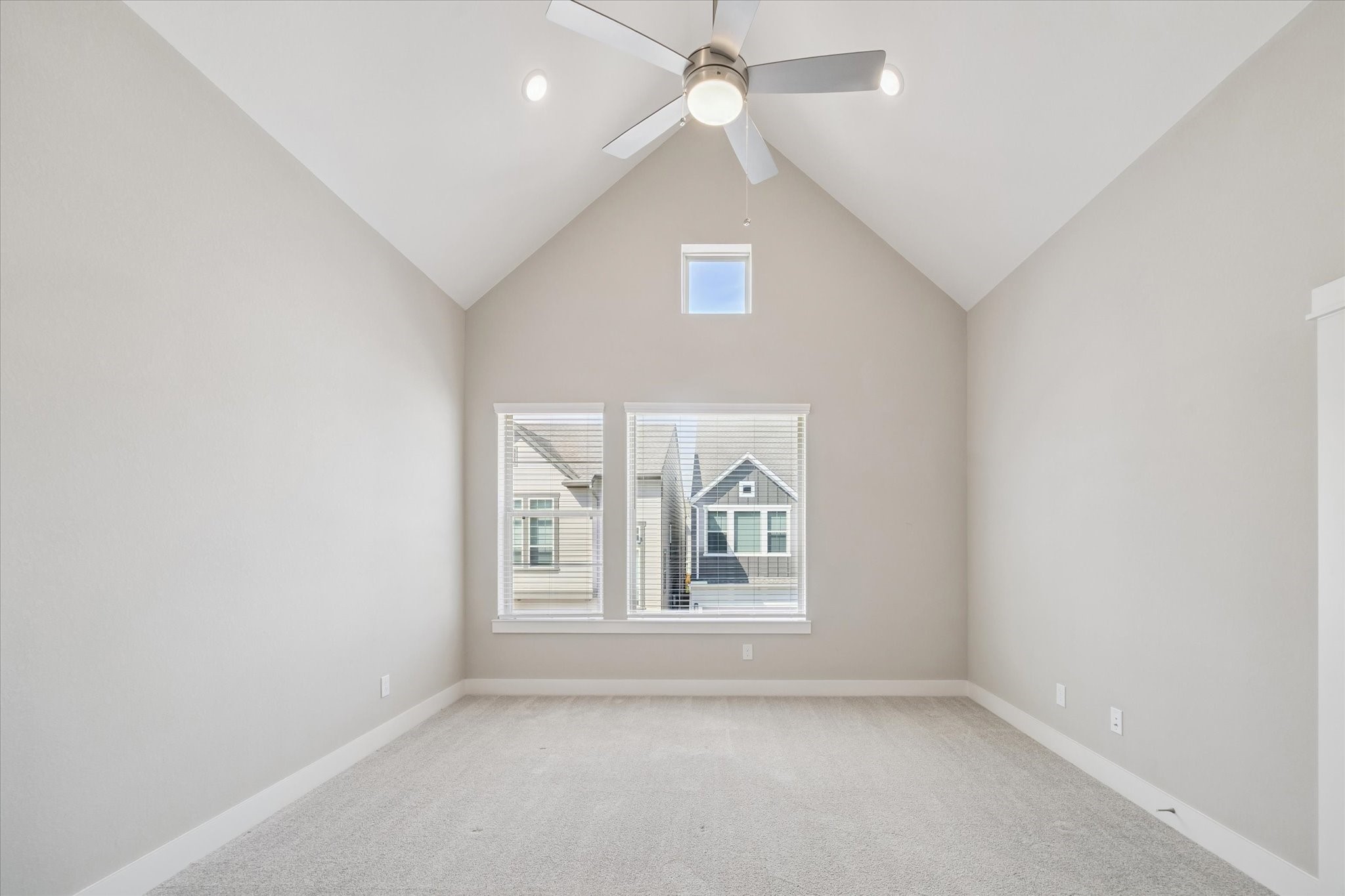 10961 Hewitt Cliff Lane Houston, TX 77043 - Photo 15 of 26 an empty room with windows and ceiling fan