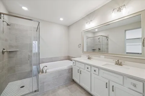 a bathroom with a double vanity sink mirror double and shower