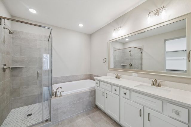 a bathroom with a double vanity sink mirror double and shower