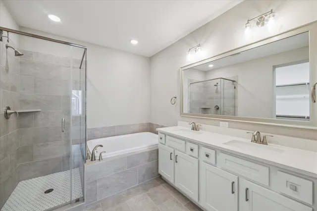 a bathroom with a double vanity sink mirror double and shower