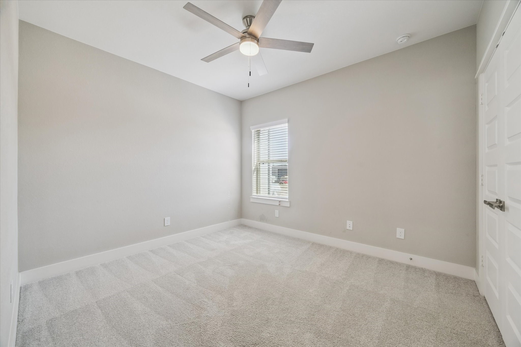 10961 Hewitt Cliff Lane Houston, TX 77043 - Photo 18 of 26 an empty room with a window and a fan