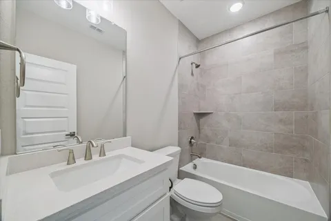 a bathroom with a sink a toilet and a bathtub