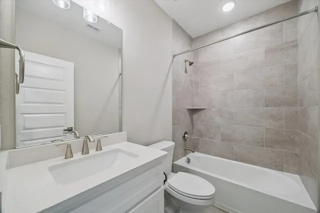 a bathroom with a sink a toilet and a bathtub