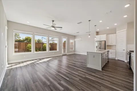 a view of kitchen with cabinets and wooden floor