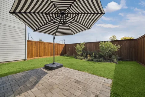 a backyard of a house with table and chairs