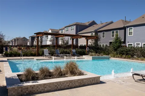 a view of a house with garden and a sitting area