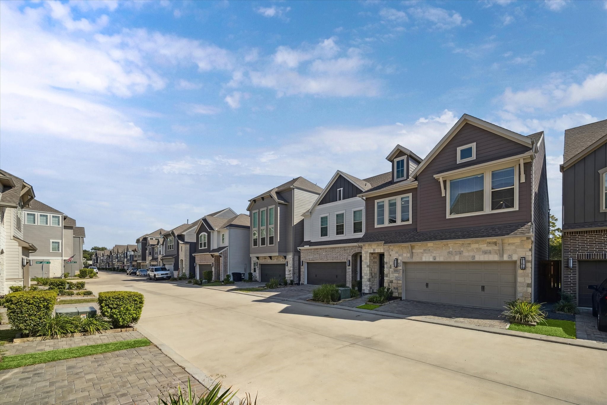 10961 Hewitt Cliff Lane Houston, TX 77043 - Photo 7 of 26 a front view of a residential apartment building with a yard