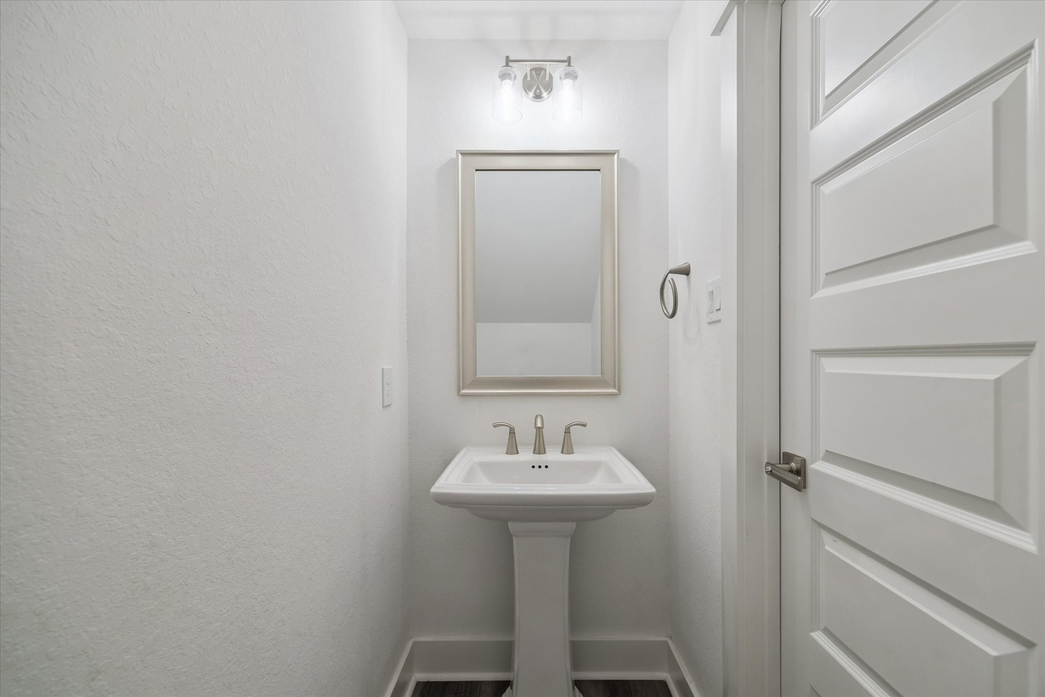 10961 Hewitt Cliff Lane Houston, TX 77043 - Photo 10 of 26 a bathroom with a sink and a mirror