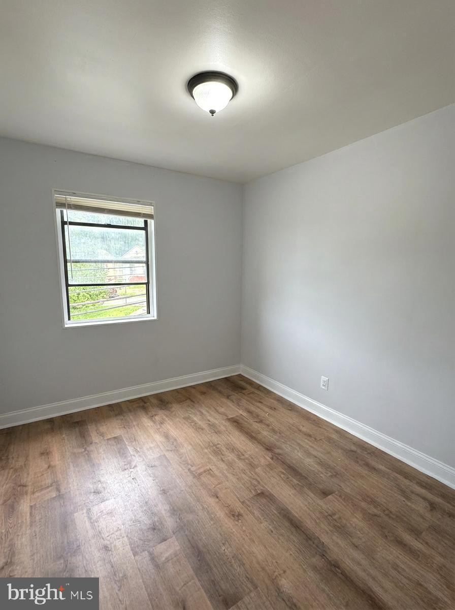 2100 Channing Street Northeast, Unit 3A Washington, DC 20018 - Photo 5 of 7 a view of an empty room with wooden floor and a window