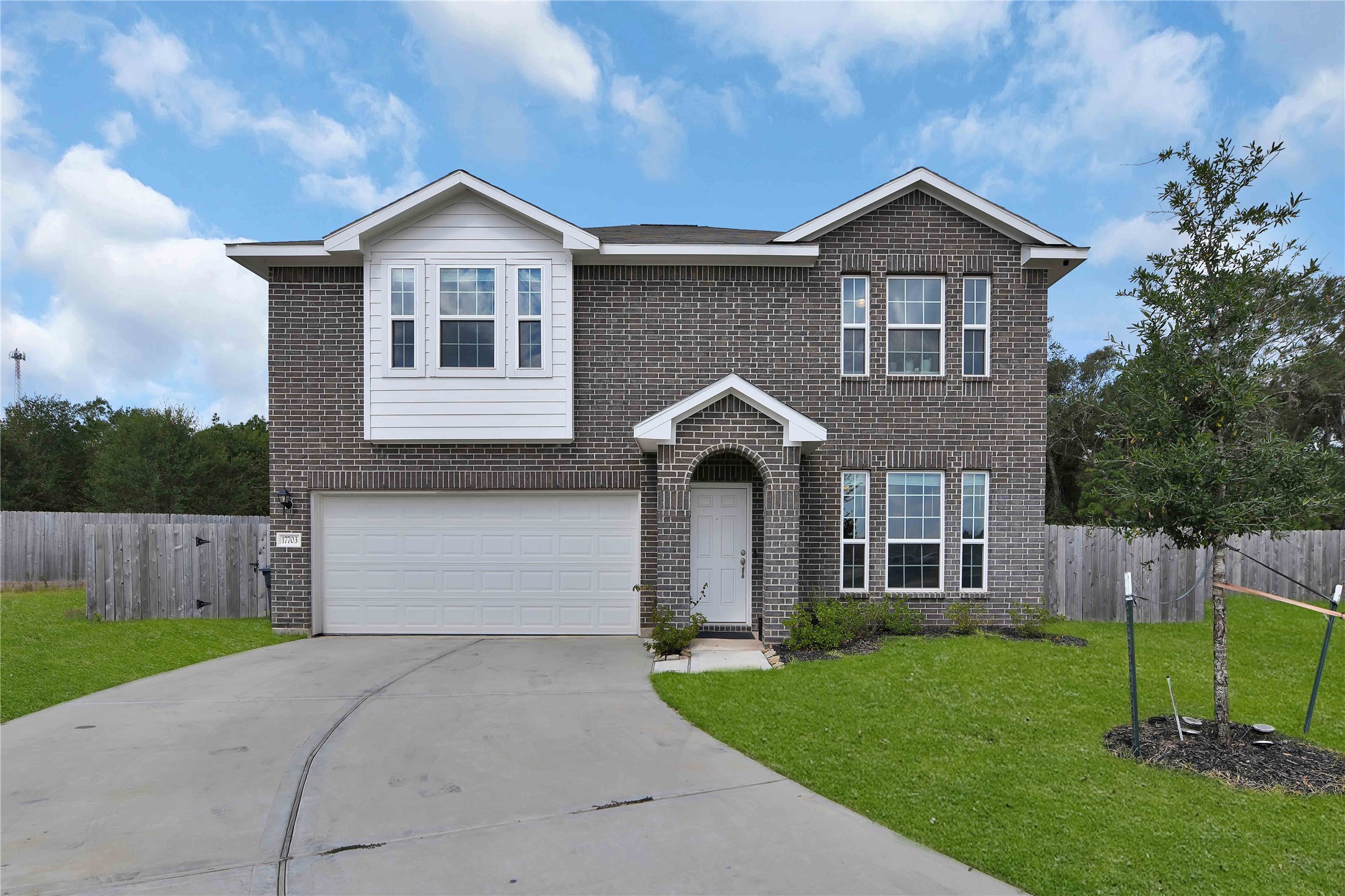 17703 Lion Heart Road Conroe, TX 77306 - Photo 1 of 26 a front view of a house with a yard and garage