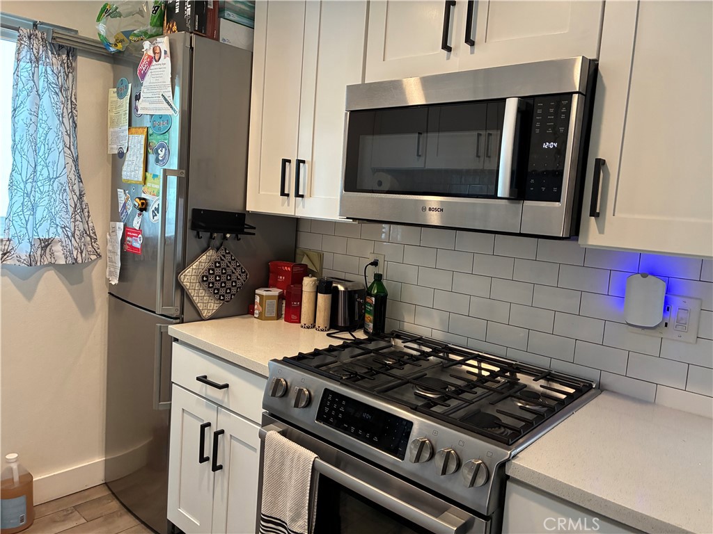 8990 19th Street, Unit 329 Rancho Cucamonga, CA 91701 - Photo 2 of 13 a kitchen with a stove and a microwave