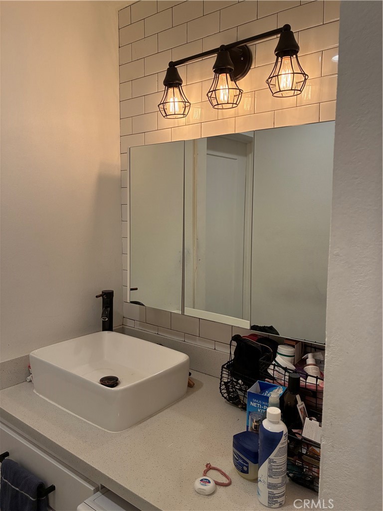 8990 19th Street, Unit 329 Rancho Cucamonga, CA 91701 - Photo 5 of 13 a bathroom with a sink and a mirror