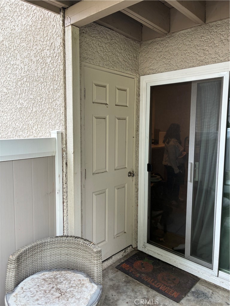 8990 19th Street, Unit 329 Rancho Cucamonga, CA 91701 - Photo 8 of 13 a view of a hallway with a glass door and bathroom