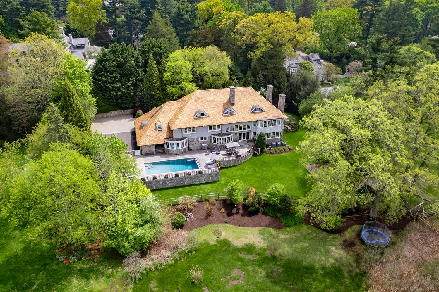 an aerial view of a house with yard and green space