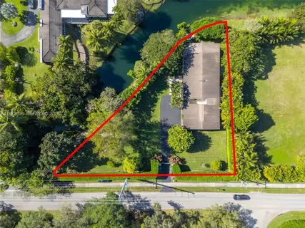 an aerial view of a house with a yard and potted plants