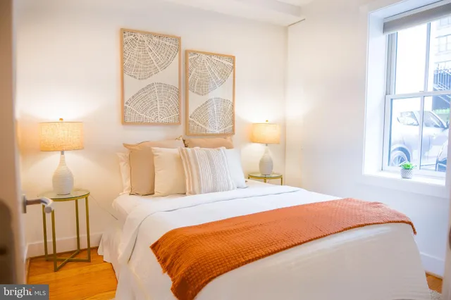 a bedroom with a bed and a lamp