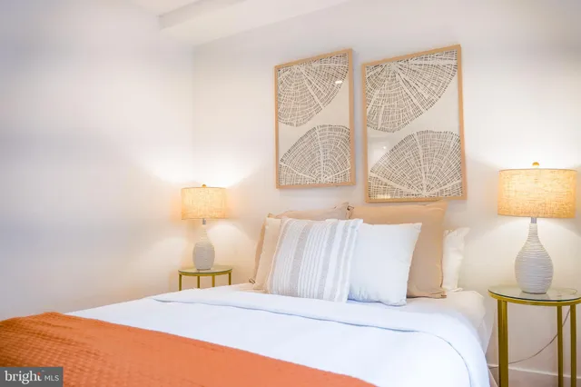 a bedroom with a bed and a lamp