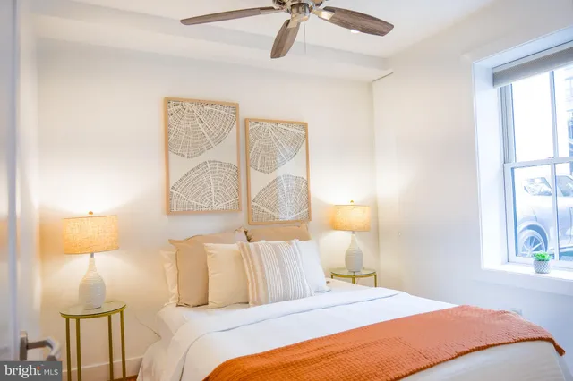 a bedroom with a bed and a lamp