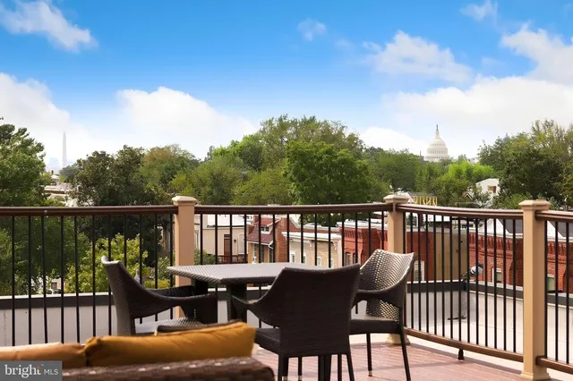 a view of a chair and table on the roof deck