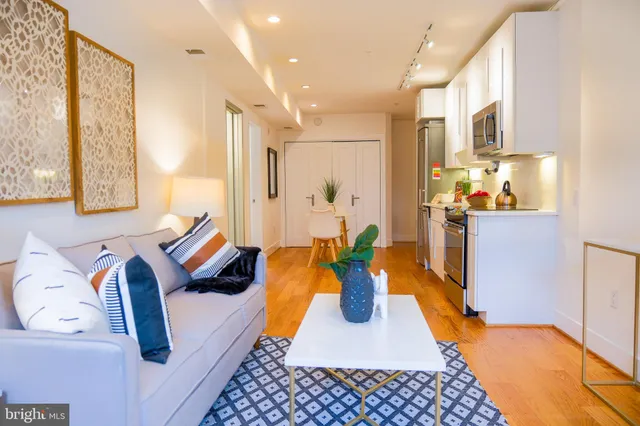 a living room with furniture and a rug
