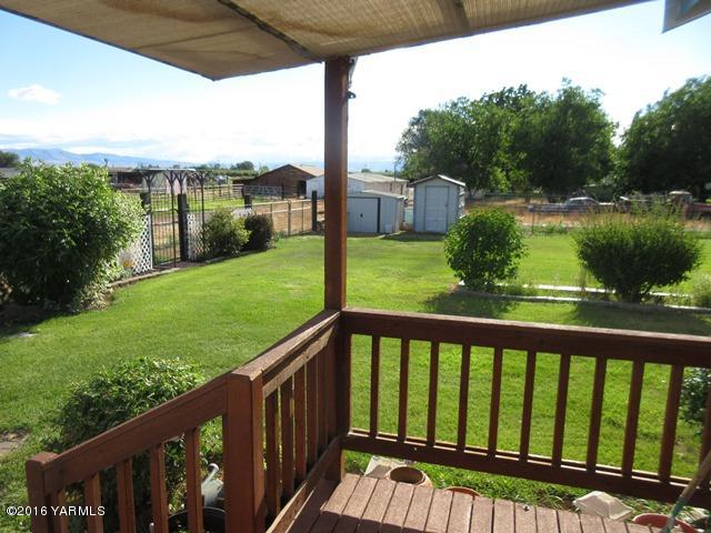 270 Evans Road Wapato, WA 98951 - Photo 32 of 42 a view of a wooden deck and a yard