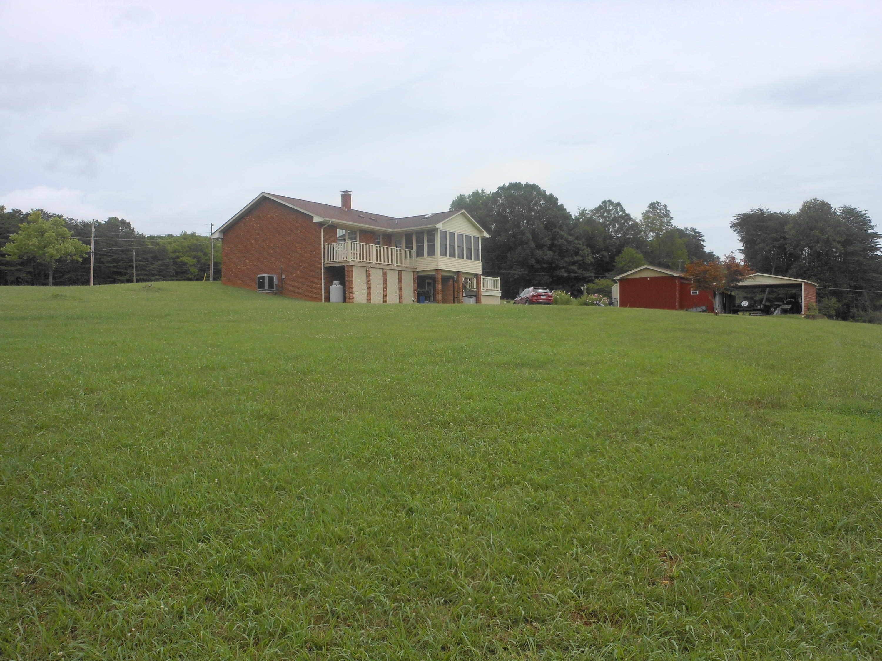 2767 Rutrough Road Southeast Roanoke, VA 24014 - Photo 2 of 36 a view of a big house with a big yard and large trees