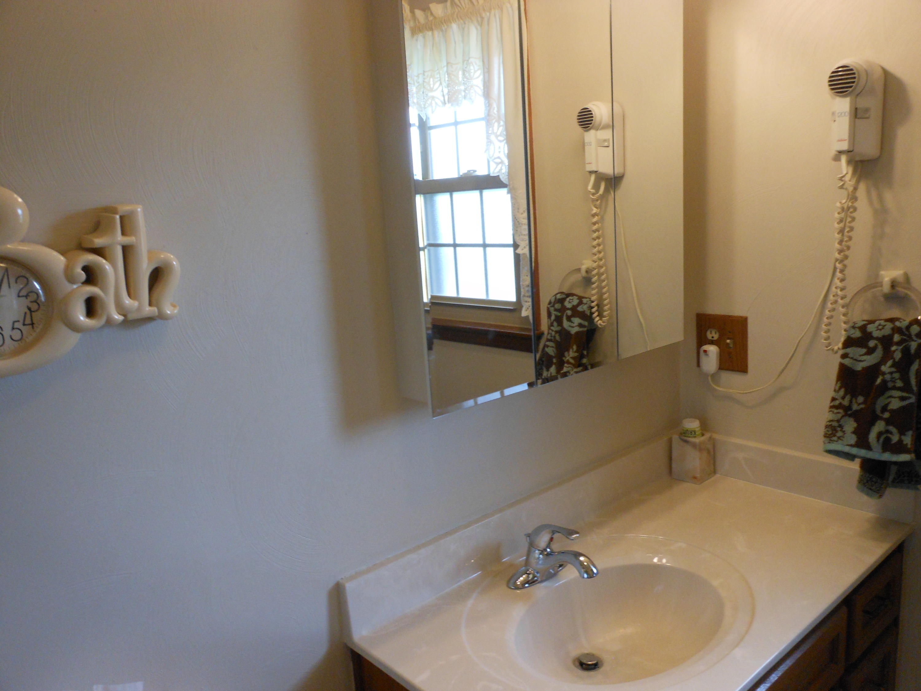 2767 Rutrough Road Southeast Roanoke, VA 24014 - Photo 12 of 36 a bathroom with a sink and a mirror