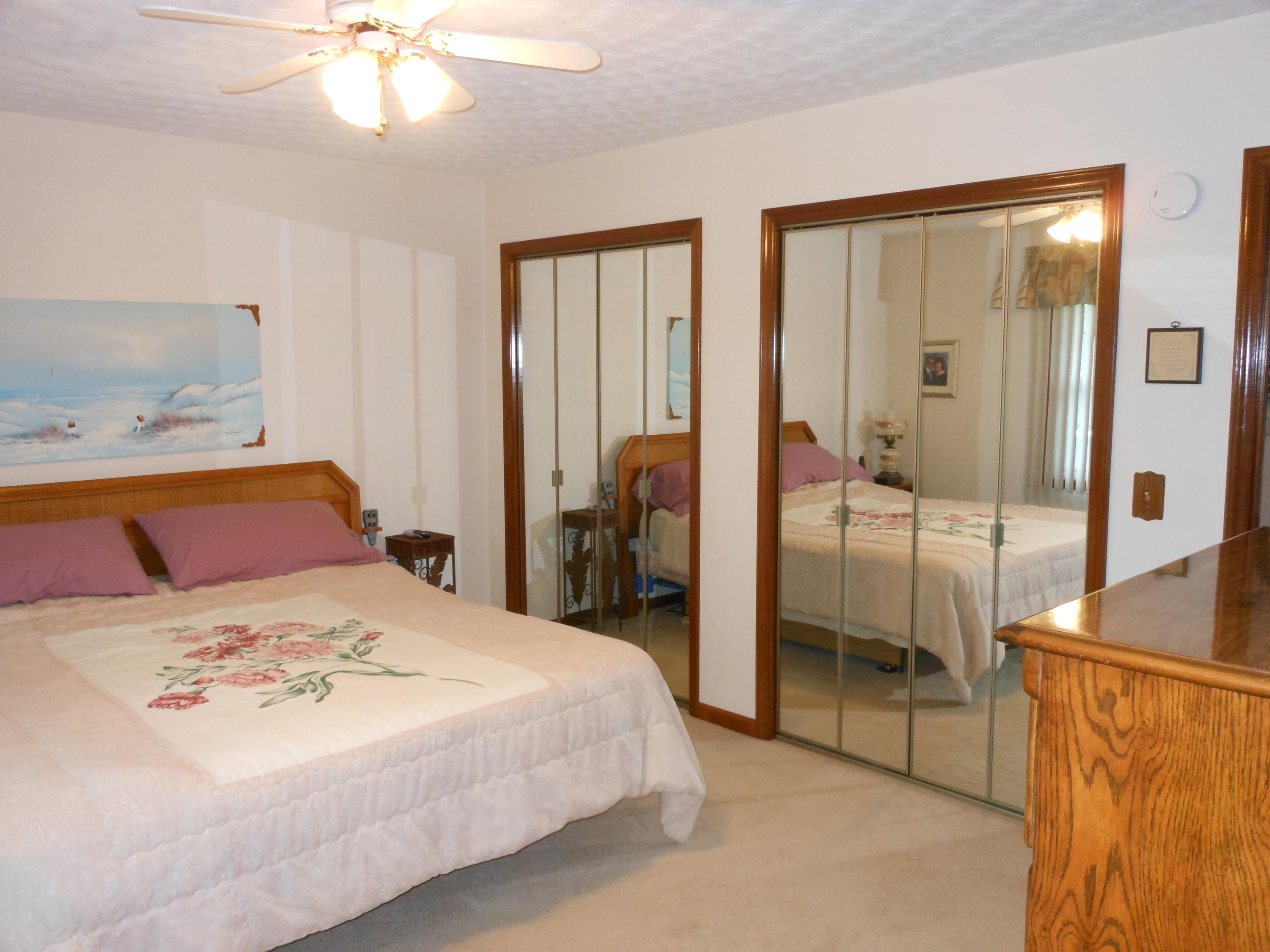 2767 Rutrough Road Southeast Roanoke, VA 24014 - Photo 13 of 36 a bedroom with a large bed and a chandelier