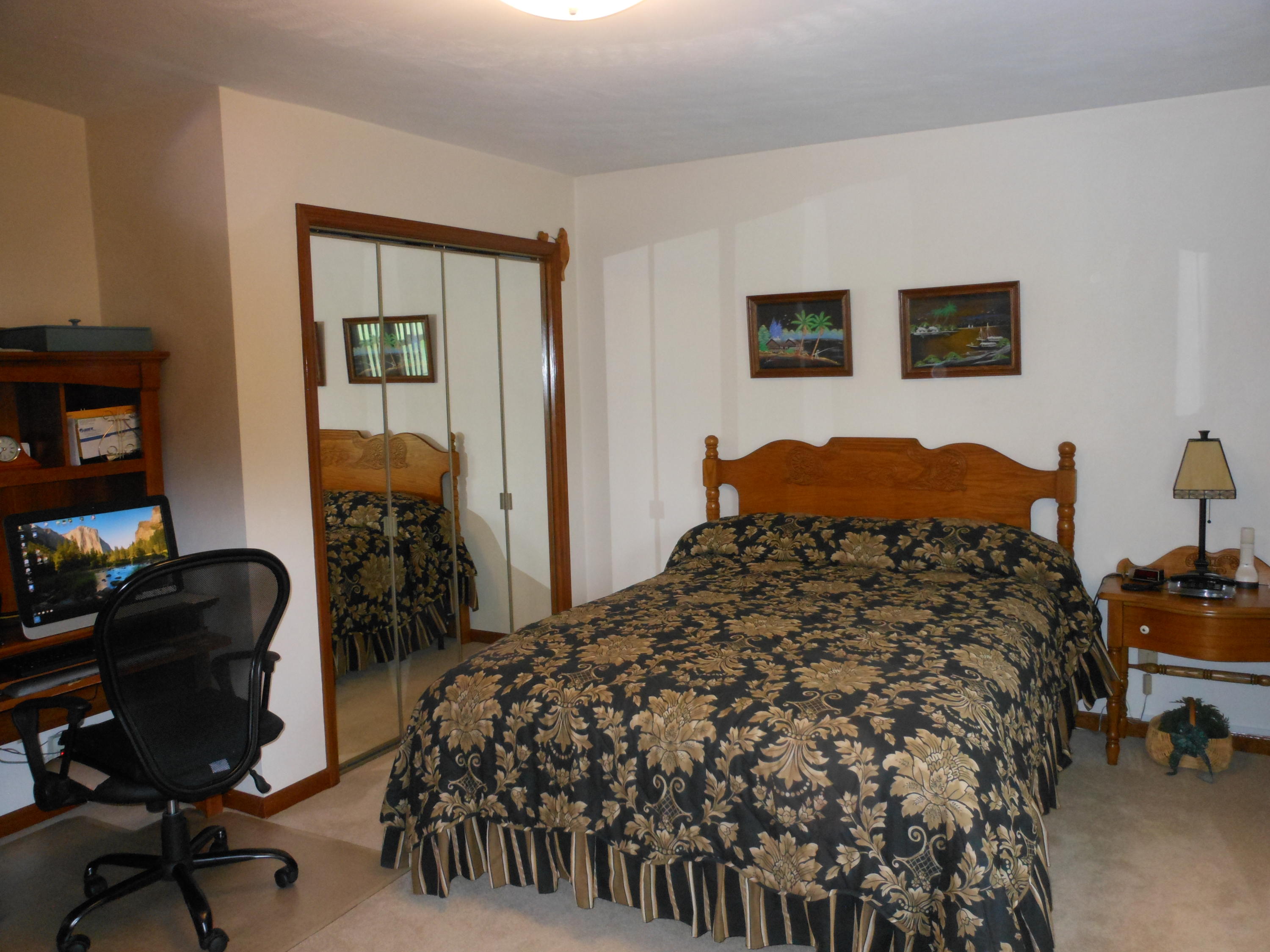 2767 Rutrough Road Southeast Roanoke, VA 24014 - Photo 15 of 36 a bed sitting in a bedroom next to a window and chair