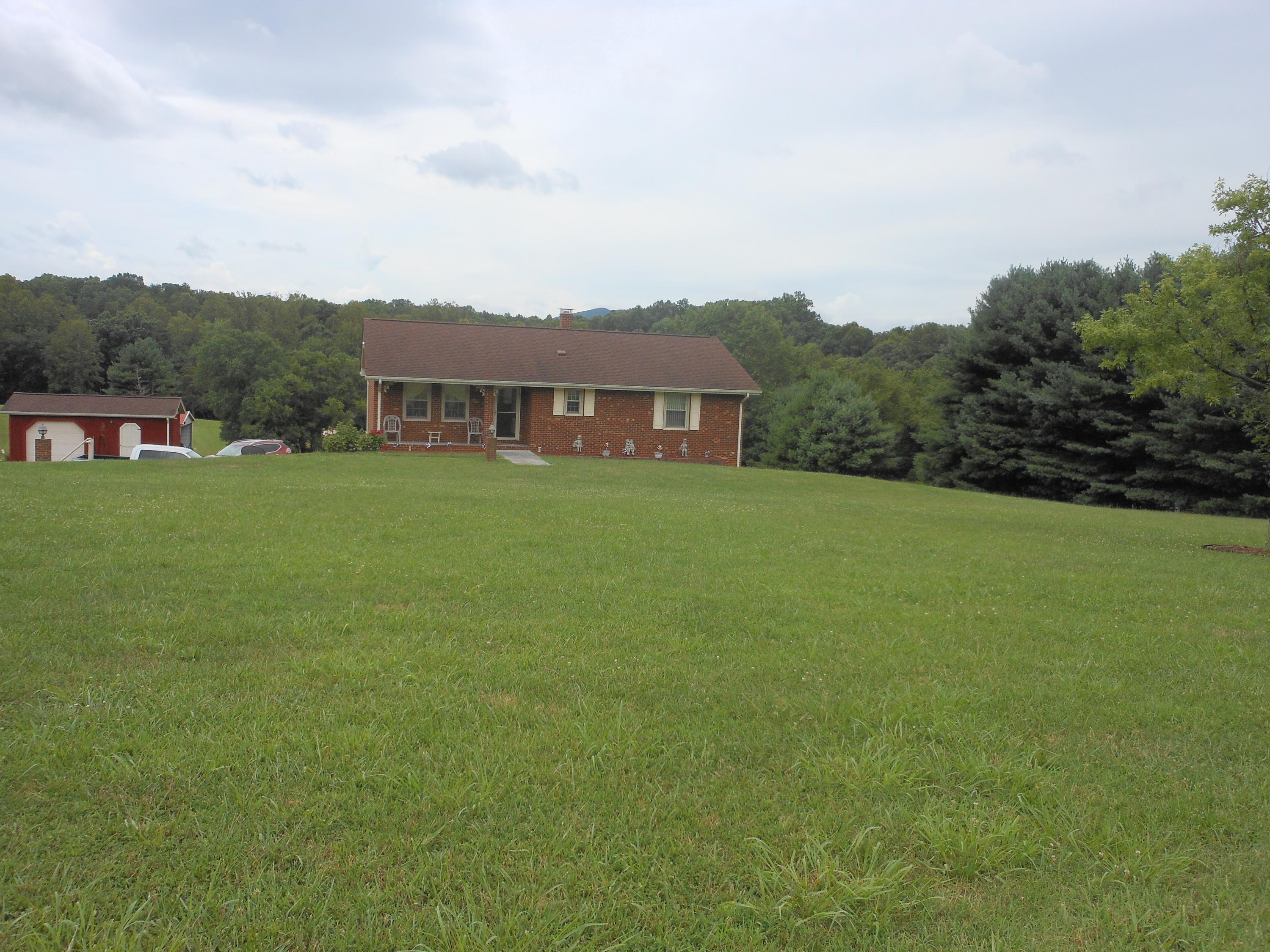 2767 Rutrough Road Southeast Roanoke, VA 24014 - Photo 3 of 36 a view of a big house with a big yard and large trees