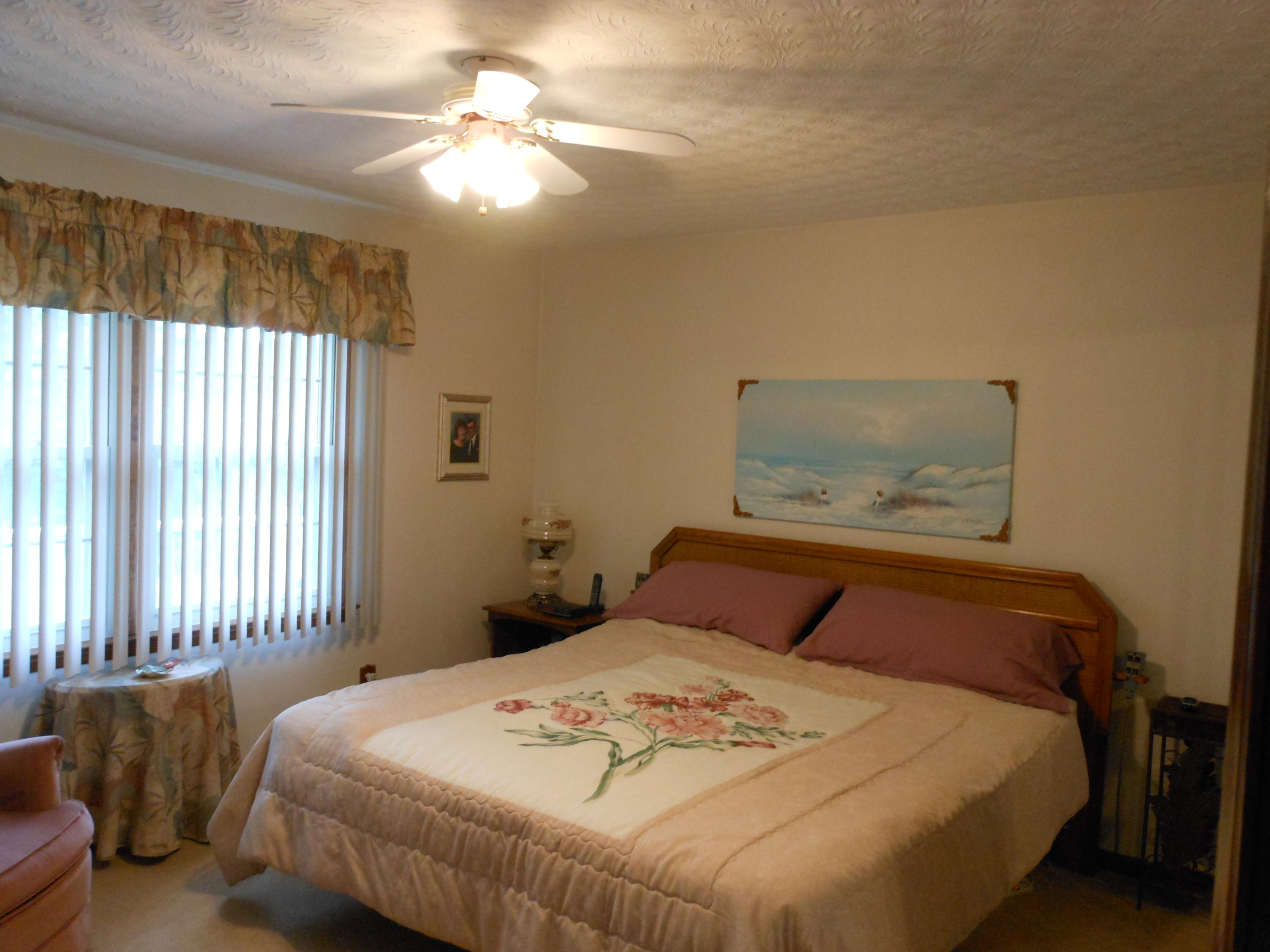 2767 Rutrough Road Southeast Roanoke, VA 24014 - Photo 9 of 36 a bedroom with a bed and a chandelier