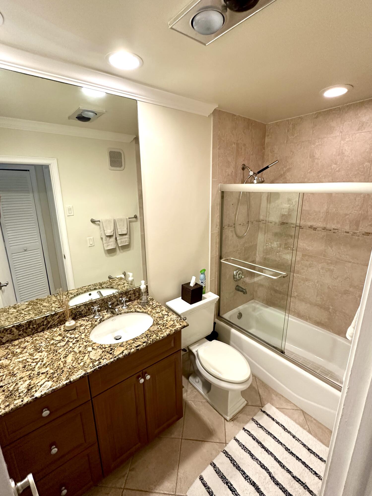 2501 South Ocean Boulevard, Unit 3040 Boca Raton, FL 33432 - Photo 13 of 22 a bathroom with a granite countertop sink toilet mirror and shower