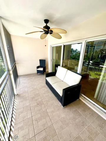 a living room with couch and a floor to ceiling window