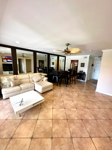a living room with furniture and dining area